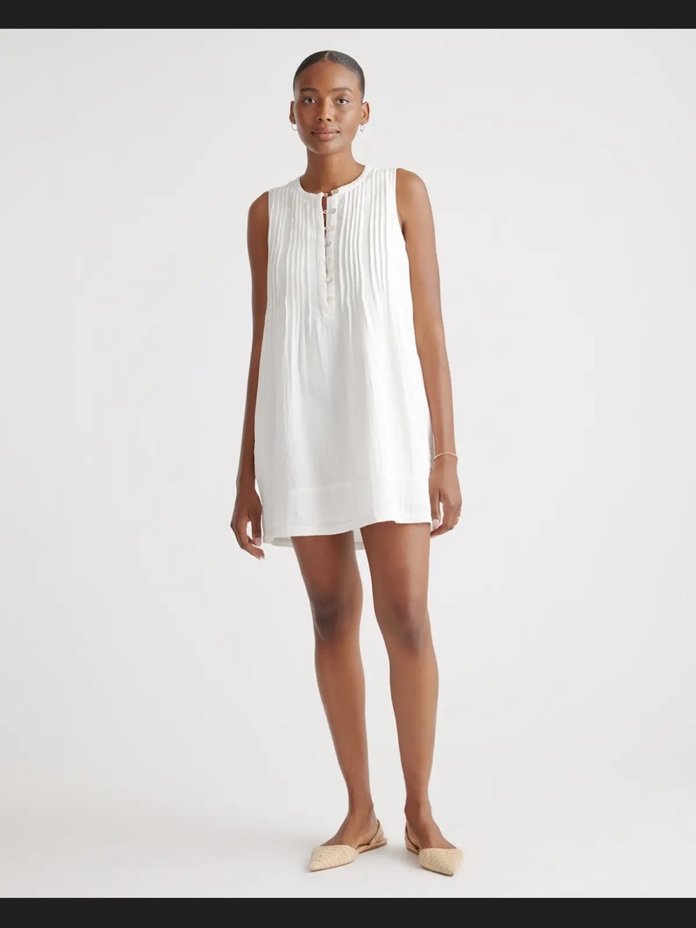 Women's white sleeveless top with buttons